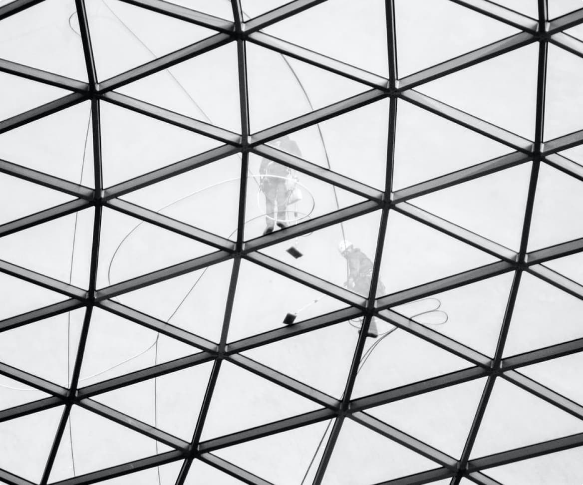 Window cleaning team on outside of glass building