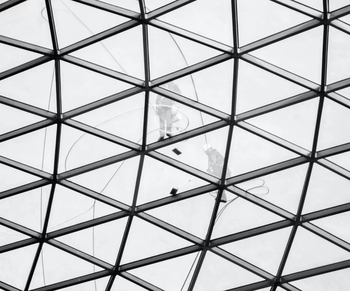 Window cleaning team on outside of glass building